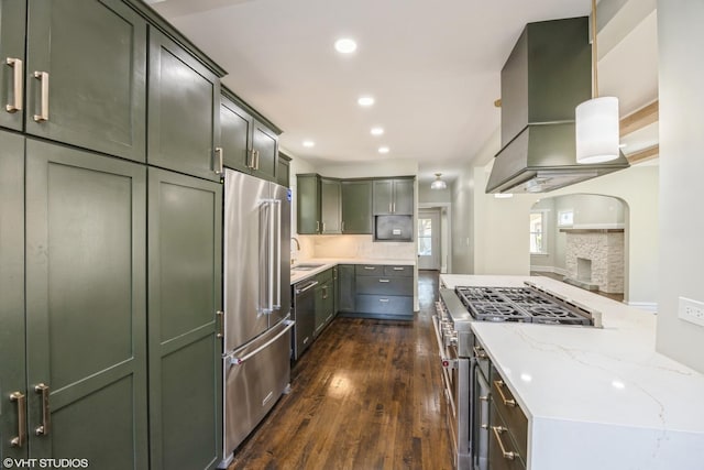 605 Home Ave, Oak Park, IL 60304 - kitchen with high quality appliances, green cabinets, wall chimney range hood, a sink, and dark wood-style floors