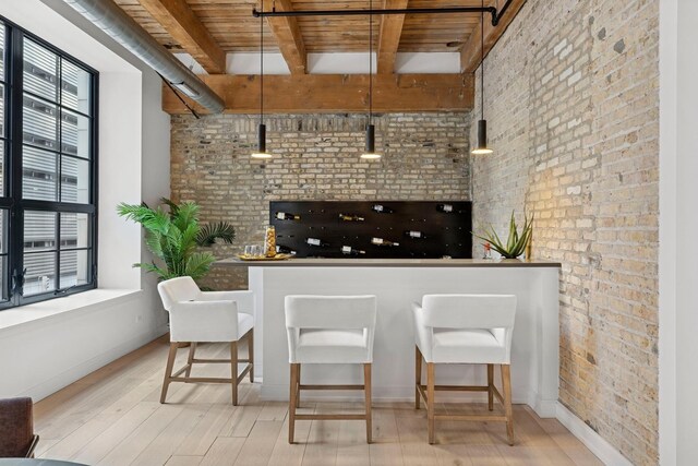 223 W Lake St Unit 3N, Chicago, IL 60606 - kitchen featuring brick wall, wooden ceiling, beamed ceiling, wood finished floors, and baseboards