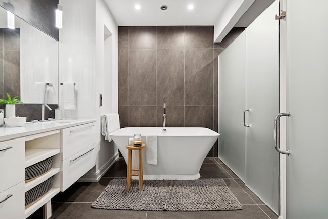 223 W Lake St Unit 3N, Chicago, IL 60606 - full bathroom featuring vanity, a soaking tub, tile walls, recessed lighting, and tile patterned flooring