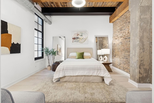 223 W Lake St Unit 3N, Chicago, IL 60606 - bedroom with beamed ceiling, light wood finished floors, baseboards, brick wall, and wooden ceiling