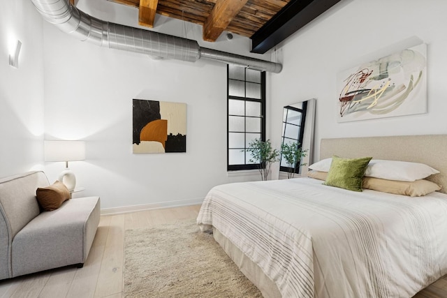 223 W Lake St Unit 3N, Chicago, IL 60606 - bedroom with wood finished floors, beamed ceiling, wooden ceiling, and baseboards