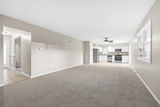 15252 Larkspur Ln, Orland Park, IL 60462 - unfurnished living room with light carpet, baseboards, and a ceiling fan