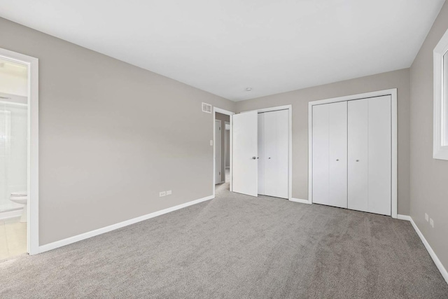 15252 Larkspur Ln, Orland Park, IL 60462 - unfurnished bedroom with two closets, carpet floors, baseboards, and connected bathroom