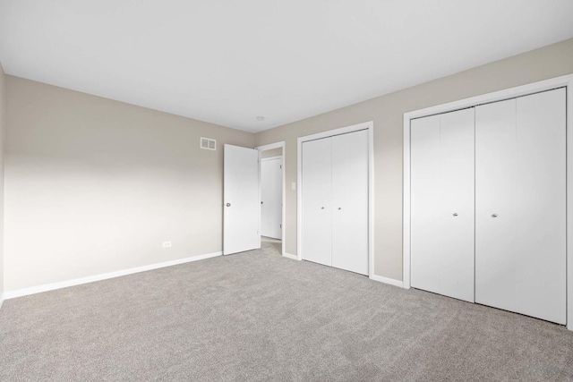 15252 Larkspur Ln, Orland Park, IL 60462 - unfurnished bedroom featuring two closets, carpet floors, and baseboards
