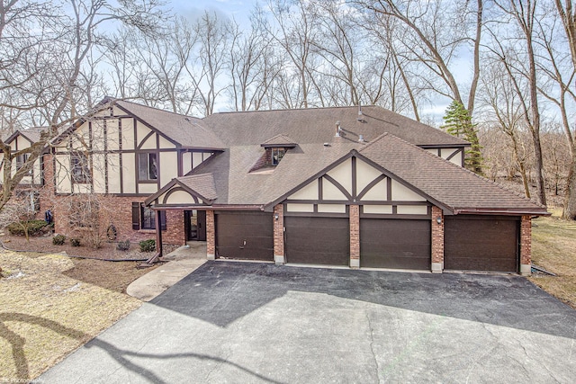 8245 Willow Dr Unit 43D, Palos Hills, IL 60465 - english style home with driveway, roof with shingles, stucco siding, an attached garage, and brick siding