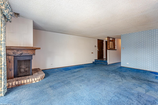 8245 Willow Dr Unit 43D, Palos Hills, IL 60465 - unfurnished living room featuring carpet flooring, a textured ceiling, and a fireplace with raised hearth