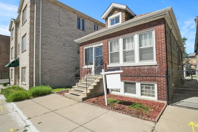 3132 Oak Park Ave, Berwyn, IL 60402 - view of front facade with brick siding, a gate, and fence