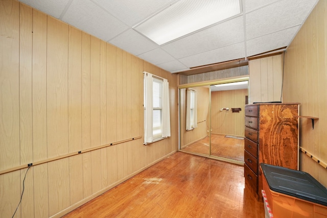 3132 Oak Park Ave, Berwyn, IL 60402 - exercise area featuring light wood-style floors, wood walls, and a drop ceiling