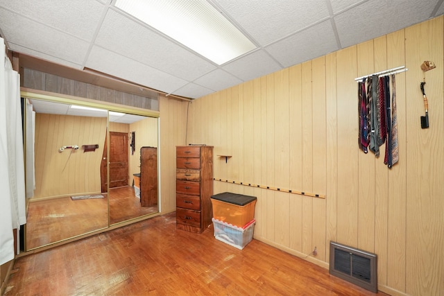 3132 Oak Park Ave, Berwyn, IL 60402 - finished basement with wood finished floors, a paneled ceiling, and wood walls