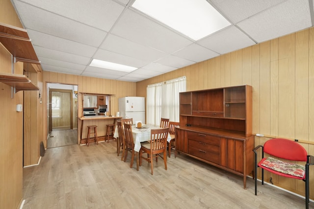 3132 Oak Park Ave, Berwyn, IL 60402 - dining room with wood walls, light wood-style flooring, and a drop ceiling