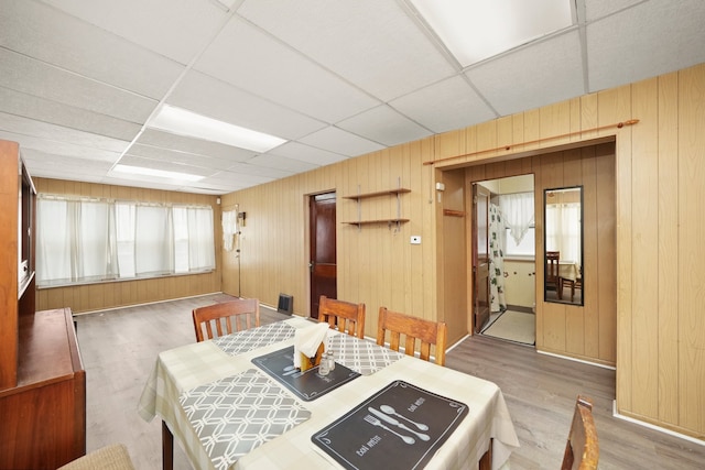 3132 Oak Park Ave, Berwyn, IL 60402 - dining space featuring wood finished floors, a drop ceiling, and wood walls
