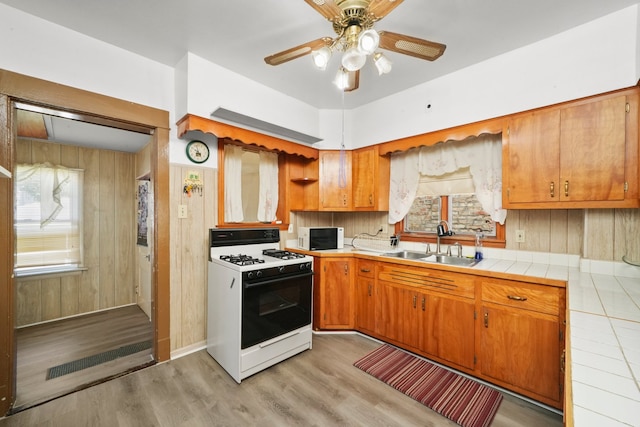 3132 Oak Park Ave, Berwyn, IL 60402 - kitchen featuring white appliances, a sink, tile countertops, light wood finished floors, and ceiling fan