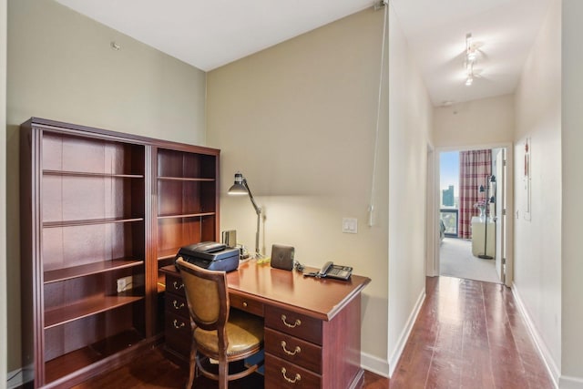 office area featuring dark wood-style flooring and baseboards