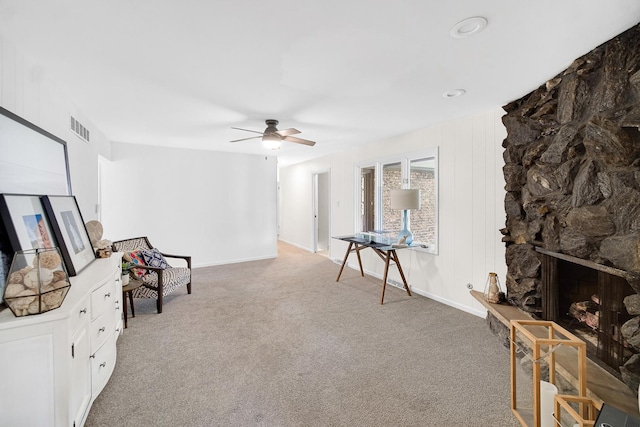 407 Meadow Ave, Frankfort, IL 60423 - living area featuring light colored carpet, ceiling fan, a stone fireplace, and baseboards