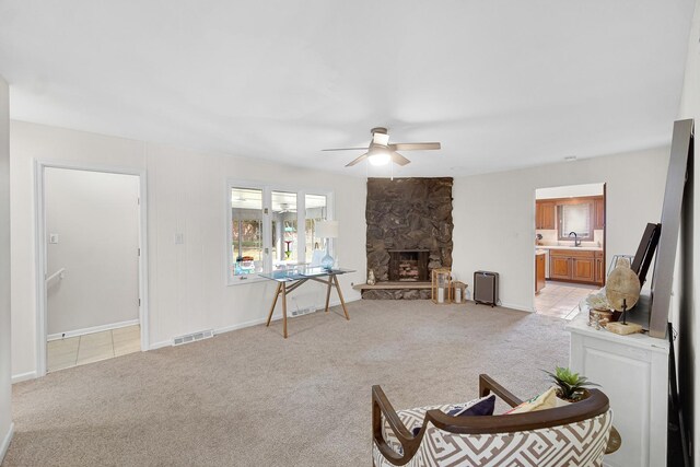 407 Meadow Ave, Frankfort, IL 60423 - living area featuring light colored carpet, a ceiling fan, a fireplace, and baseboards