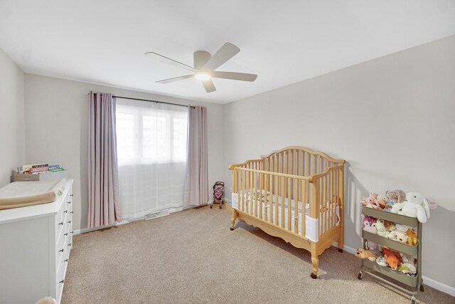 407 Meadow Ave, Frankfort, IL 60423 - bedroom featuring light carpet, baseboards, a nursery area, and ceiling fan