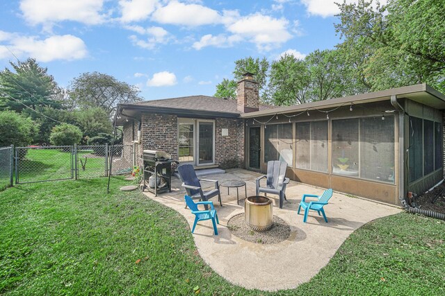 407 Meadow Ave, Frankfort, IL 60423 - back of house with a gate, a patio, a chimney, a sunroom, and brick siding