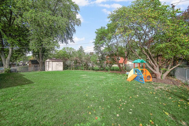 407 Meadow Ave, Frankfort, IL 60423 - view of yard featuring a playground, a storage unit, and an outdoor structure