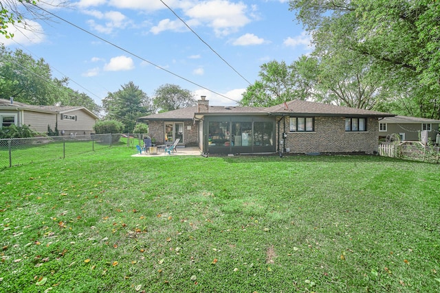 407 Meadow Ave, Frankfort, IL 60423 - rear view of house featuring a sunroom, a patio, brick siding, and a chimney