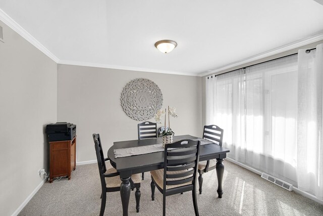 407 Meadow Ave, Frankfort, IL 60423 - dining room with light carpet, crown molding, and baseboards