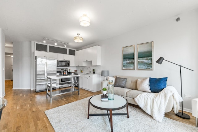 living room featuring light wood-style floors and baseboards