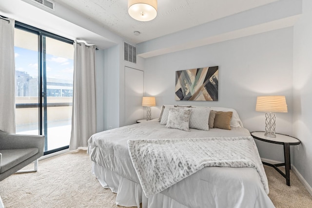 bedroom with light carpet, access to exterior, and baseboards
