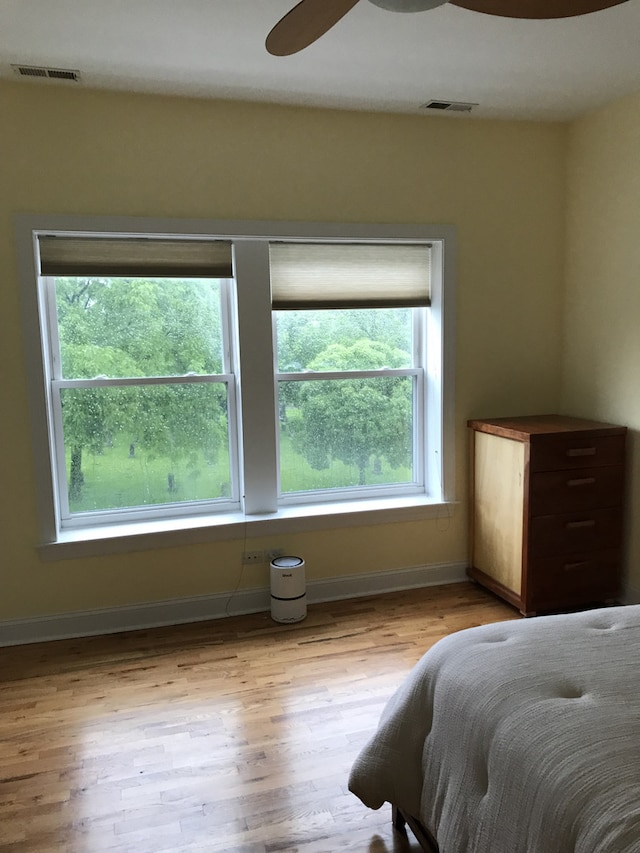 bedroom with wood finished floors, ceiling fan, and baseboards