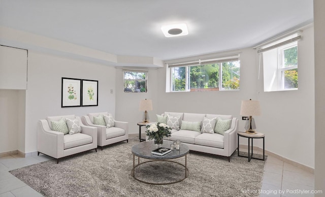 tiled living room featuring plenty of natural light and baseboards
