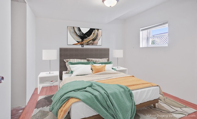 bedroom featuring wood finished floors and baseboards