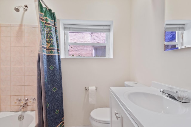 bathroom featuring toilet, vanity, and shower / bath combo