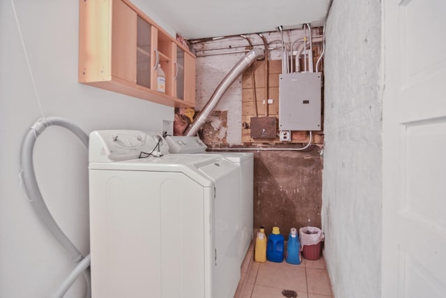 laundry area featuring electric panel, separate washer and dryer, and tile patterned flooring