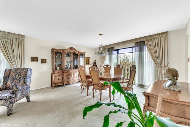 1535 Forest Ave Unit 504, River Forest, IL 60305 - dining room with light colored carpet, a chandelier, and baseboards