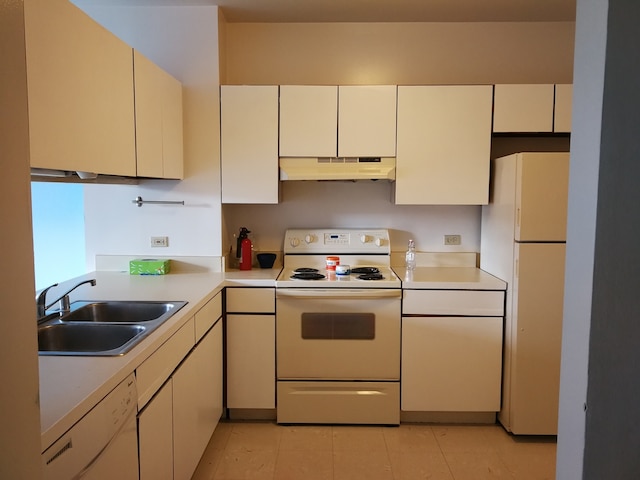 kitchen with white appliances, a sink, under cabinet range hood, light countertops, and light tile patterned floors
