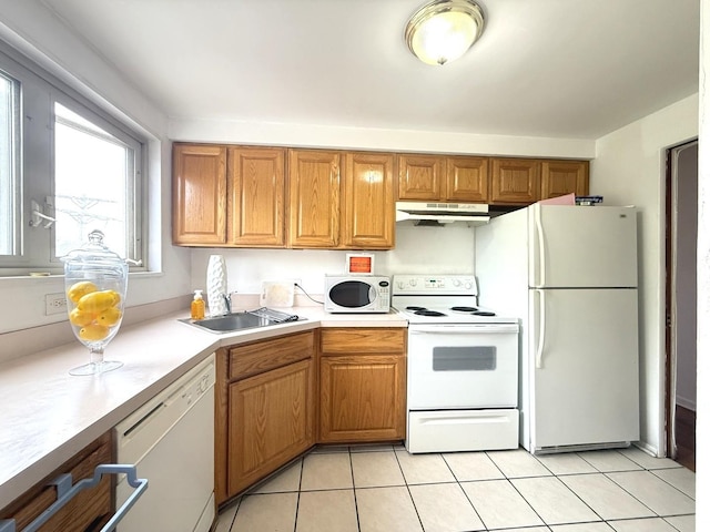2014 W 111th St Unit 2N, Chicago, IL 60643 - kitchen with white appliances, under cabinet range hood, a sink, light countertops, and light tile patterned floors
