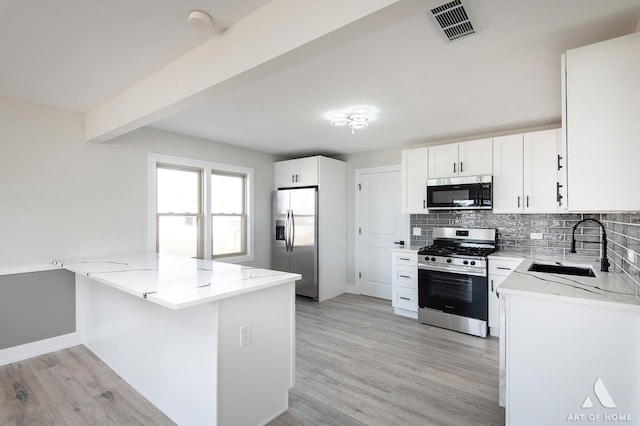 10925 Lyman Ave, Chicago Ridge, IL 60415 - kitchen with appliances with stainless steel finishes, light stone counters, a sink, backsplash, and light wood-style floors