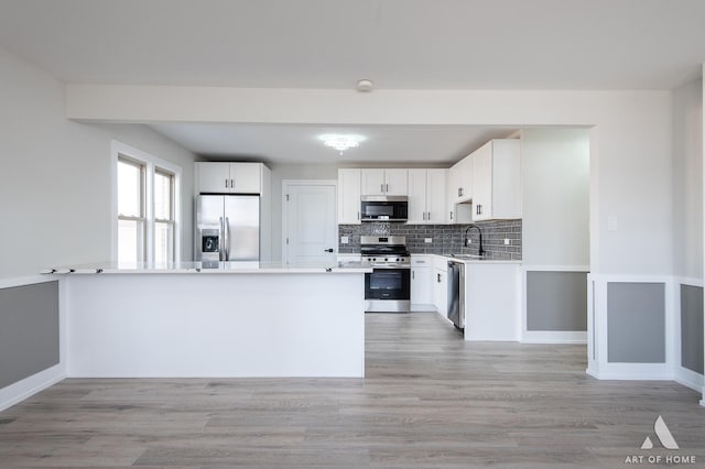 10925 Lyman Ave, Chicago Ridge, IL 60415 - kitchen with appliances with stainless steel finishes, a sink, decorative backsplash, and white cabinets