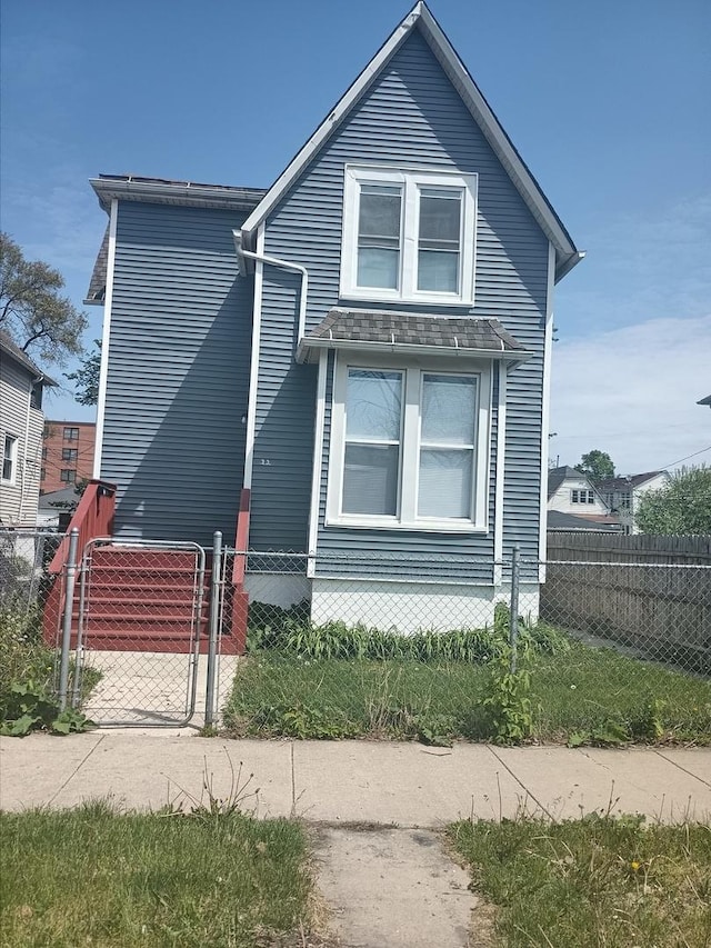 22 E 118th St, Chicago, IL 60628 - view of front of home with a fenced front yard and a gate