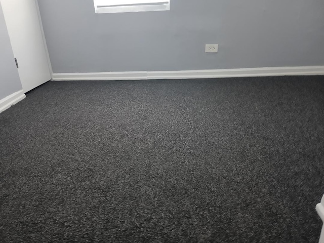 22 E 118th St, Chicago, IL 60628 - empty room with dark carpet and baseboards