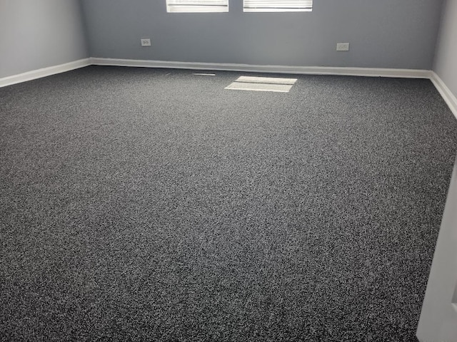 22 E 118th St, Chicago, IL 60628 - spare room featuring dark colored carpet and baseboards