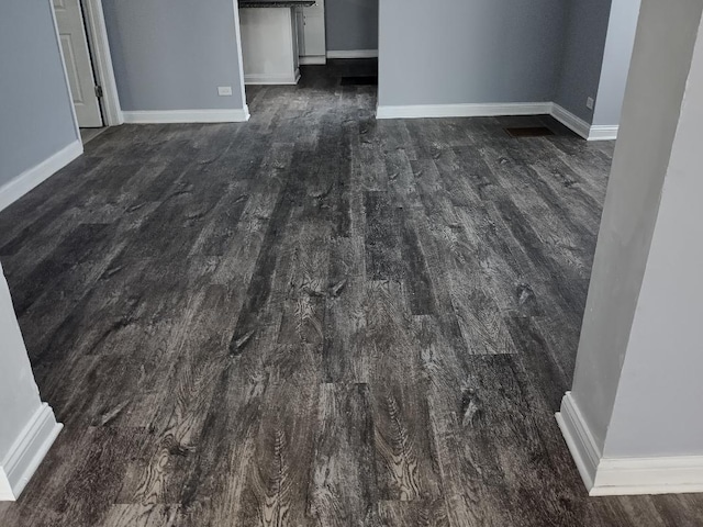 22 E 118th St, Chicago, IL 60628 - spare room with dark wood finished floors and baseboards