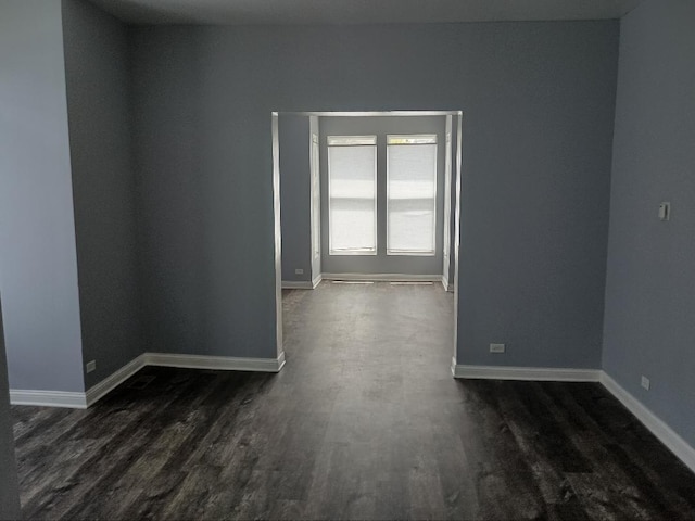 22 E 118th St, Chicago, IL 60628 - empty room featuring dark wood-style flooring and baseboards