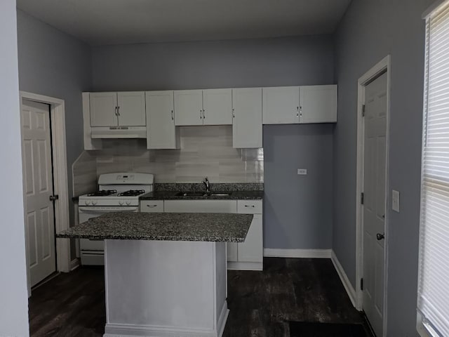 22 E 118th St, Chicago, IL 60628 - kitchen with white range with gas stovetop, a sink, white cabinets, under cabinet range hood, and a center island