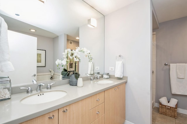 full bath featuring tile patterned floors, double vanity, baseboards, and recessed lighting