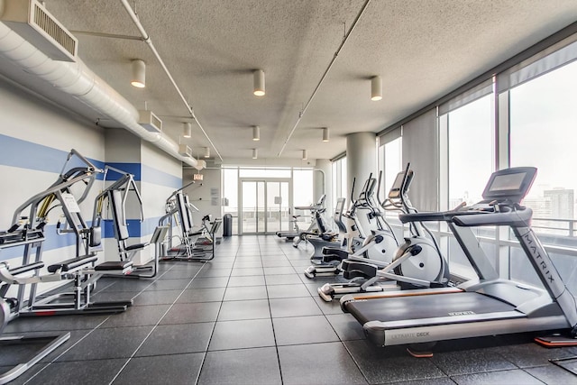 workout area with healthy amount of natural light and a textured ceiling