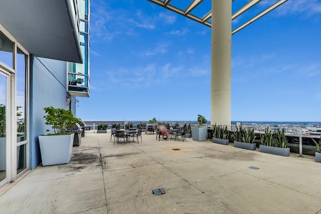 view of patio with outdoor dining space and a balcony