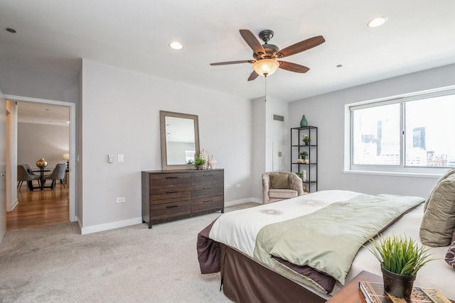 bedroom with light colored carpet, recessed lighting, baseboards, and a ceiling fan