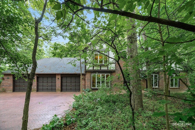 42W325 Jens Jensen Ln, Saint Charles, IL 60175 - view of front of property featuring driveway, a garage, and brick siding