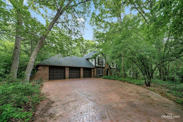 42W325 Jens Jensen Ln, Saint Charles, IL 60175 - view of side of property featuring decorative driveway and an attached garage