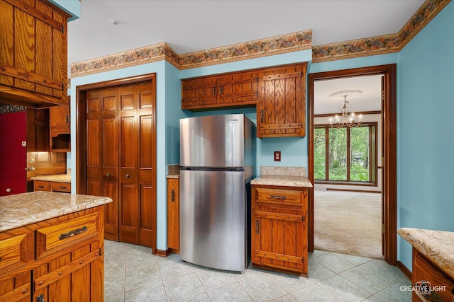 42W325 Jens Jensen Ln, Saint Charles, IL 60175 - kitchen with freestanding refrigerator, light tile patterned flooring, a chandelier, brown cabinetry, and light carpet