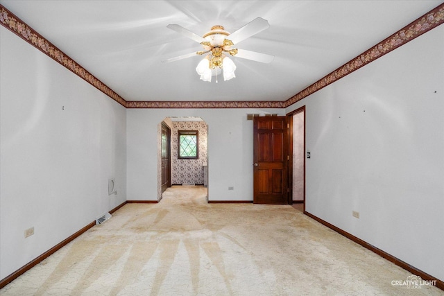 42W325 Jens Jensen Ln, Saint Charles, IL 60175 - empty room featuring arched walkways, baseboards, light carpet, and ceiling fan
